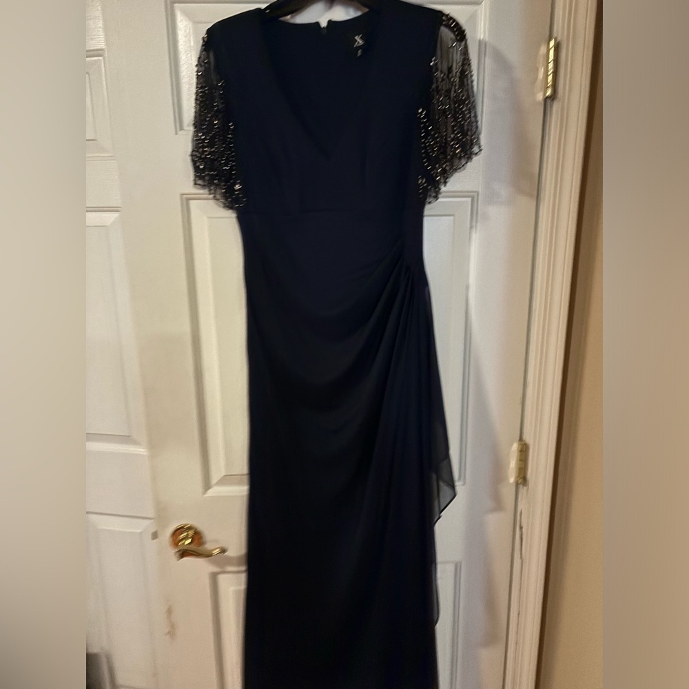 Long, formal blue dress with bead accent.